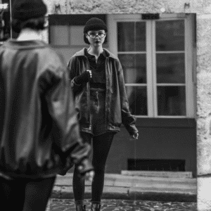 A black and white image of a girl looking in a mirror to represent the astrological energy of this week and the reflections that accompany it.