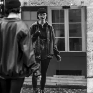 A black and white image of a girl looking in a mirror to represent the astrological energy of this week and the reflections that accompany it.