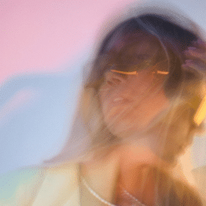 A double exposure of a woman with a sunset-coloured background to represent the energy of Jupiter going direct in Cancer.