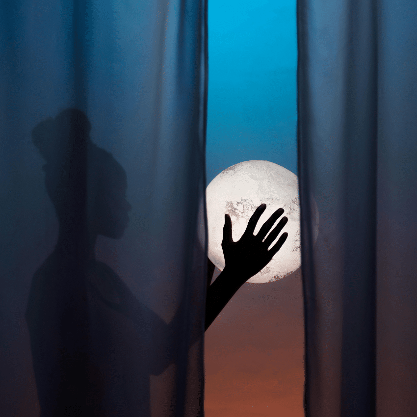 A woman holds a glowing orb representing the lunar energy for May 2026.