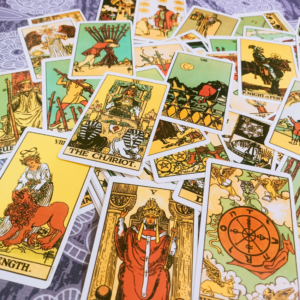 A spread of brightly colored Tarot cards to represent the energy of May Tarot horoscopes.