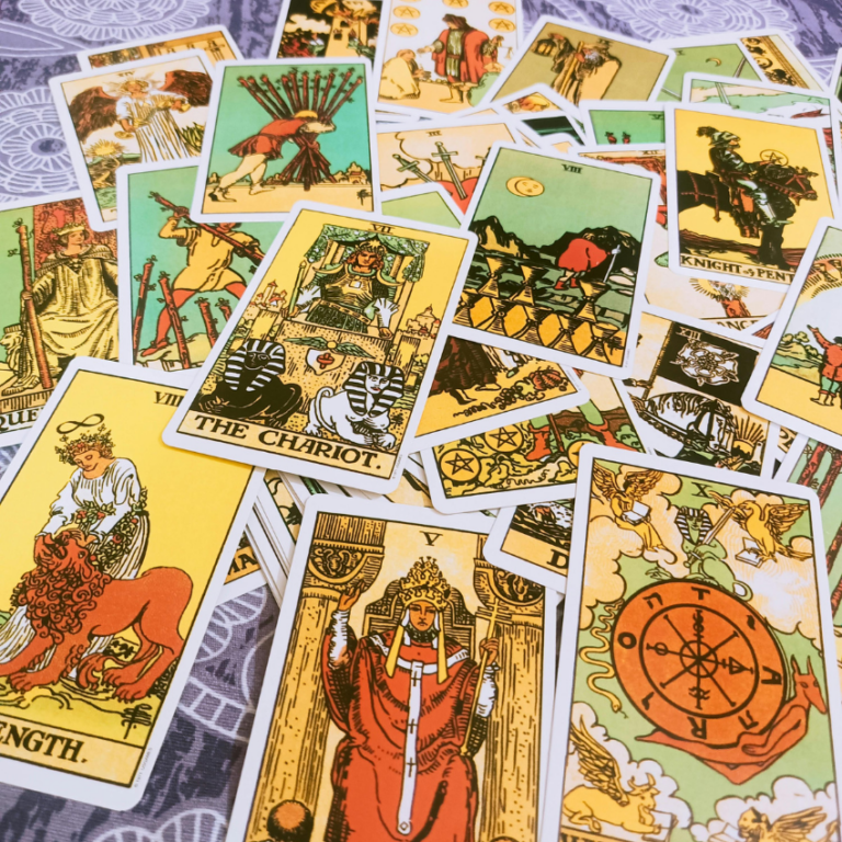 A spread of brightly colored Tarot cards to represent the energy of May Tarot horoscopes.